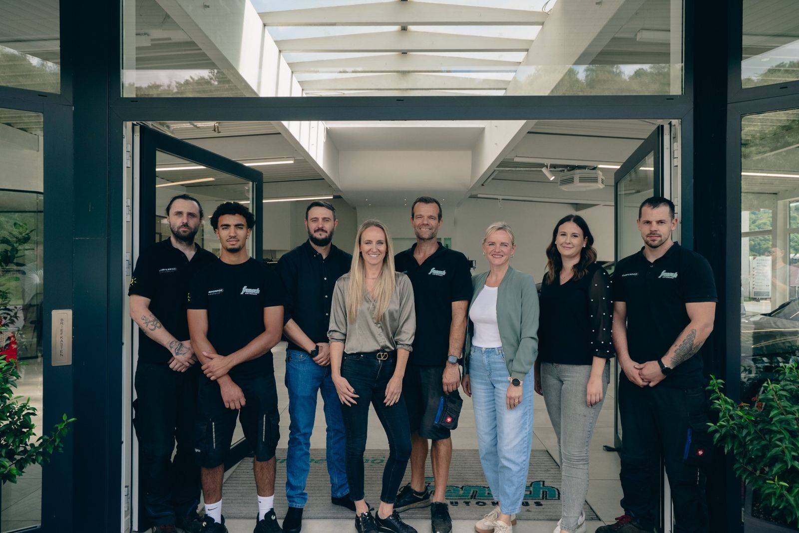 Das Team des Autohaus Frensch vor dem Eingang des Autohauses
